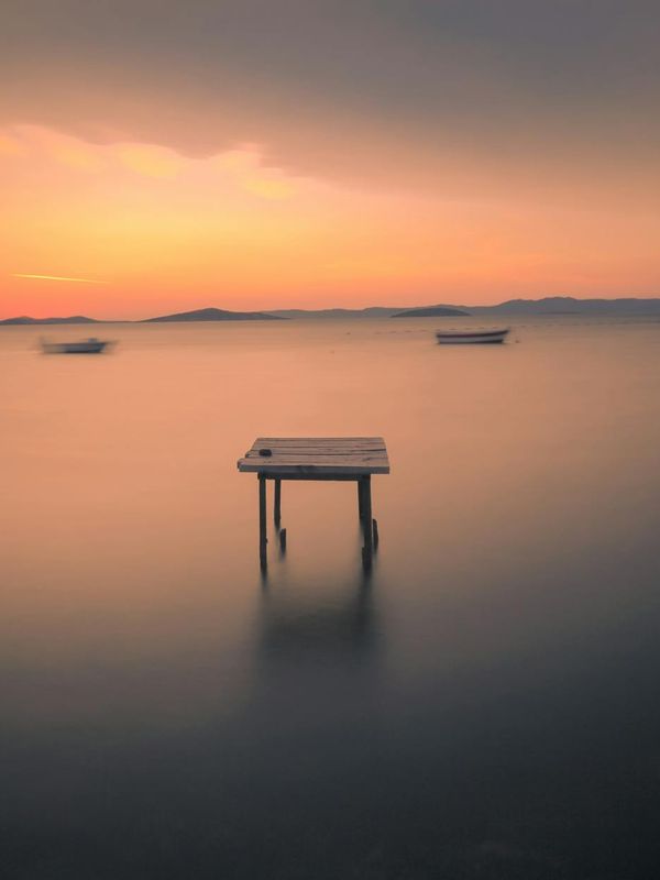 A tranquil scene of still water reflecting the sky.